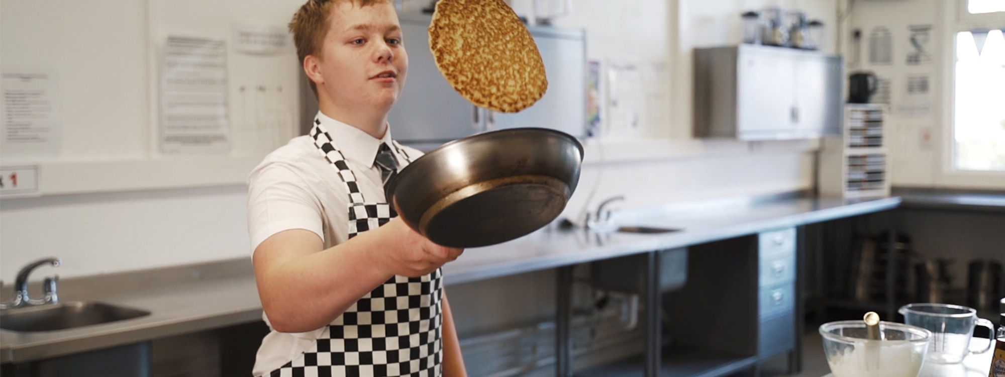 Student cooking pancakes